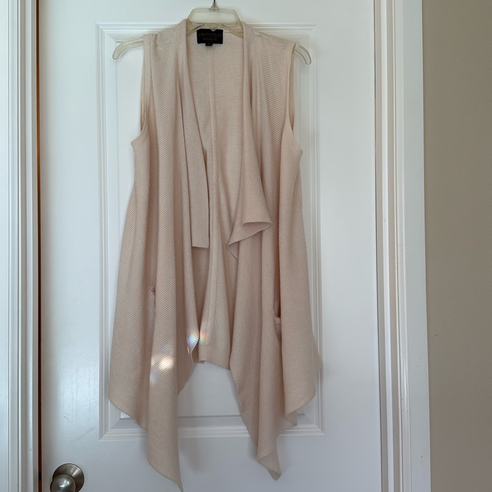 Sleeveless draped vest.